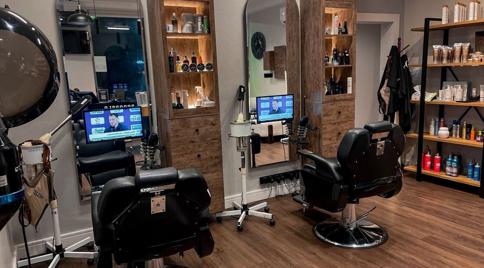 Modern interior of Poco Pelo Barbershop in Al Khobar, Eastern Province, SA featuring stylish barber chairs and products.