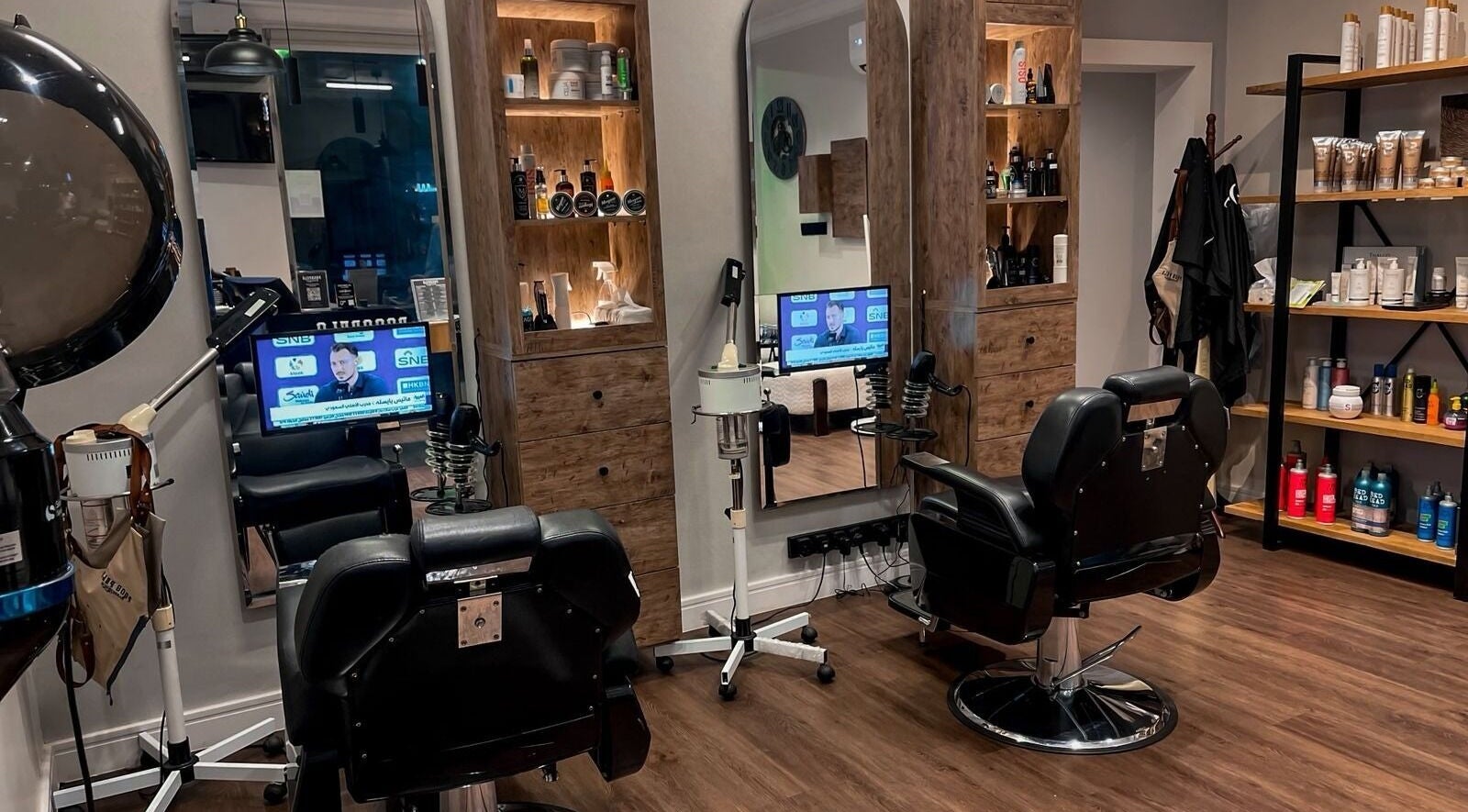 Modern interior of Poco Pelo Barbershop in Al Khobar, Eastern Province, SA featuring stylish barber chairs and products.