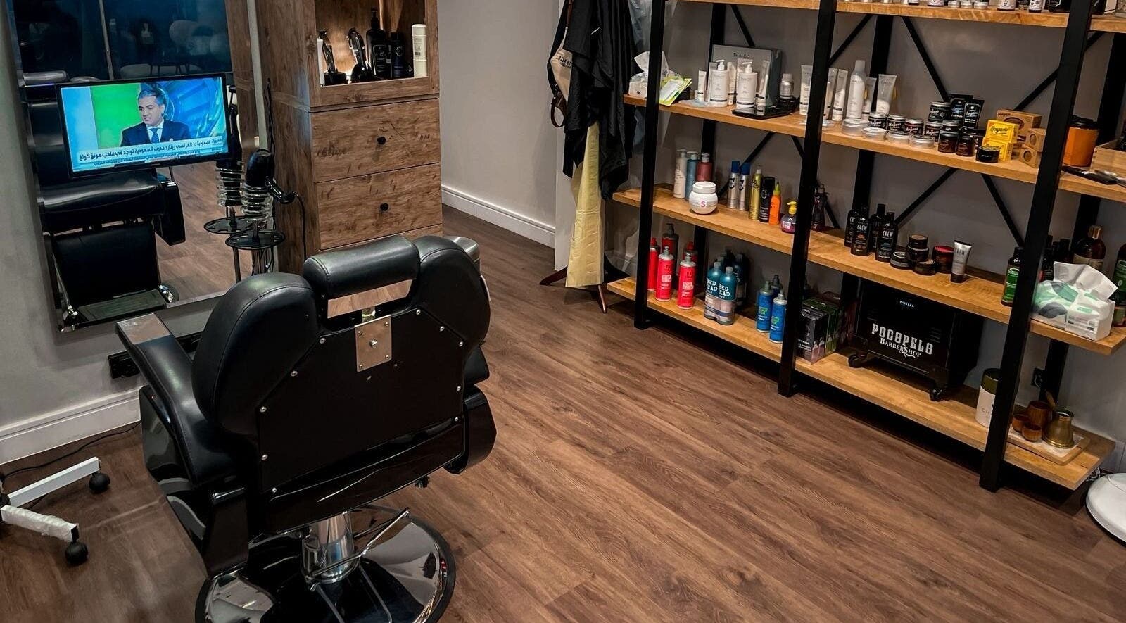 Modern barber chair and product shelves at Poco Pelo Barbershop, Al Khobar, Eastern Province, SA.
