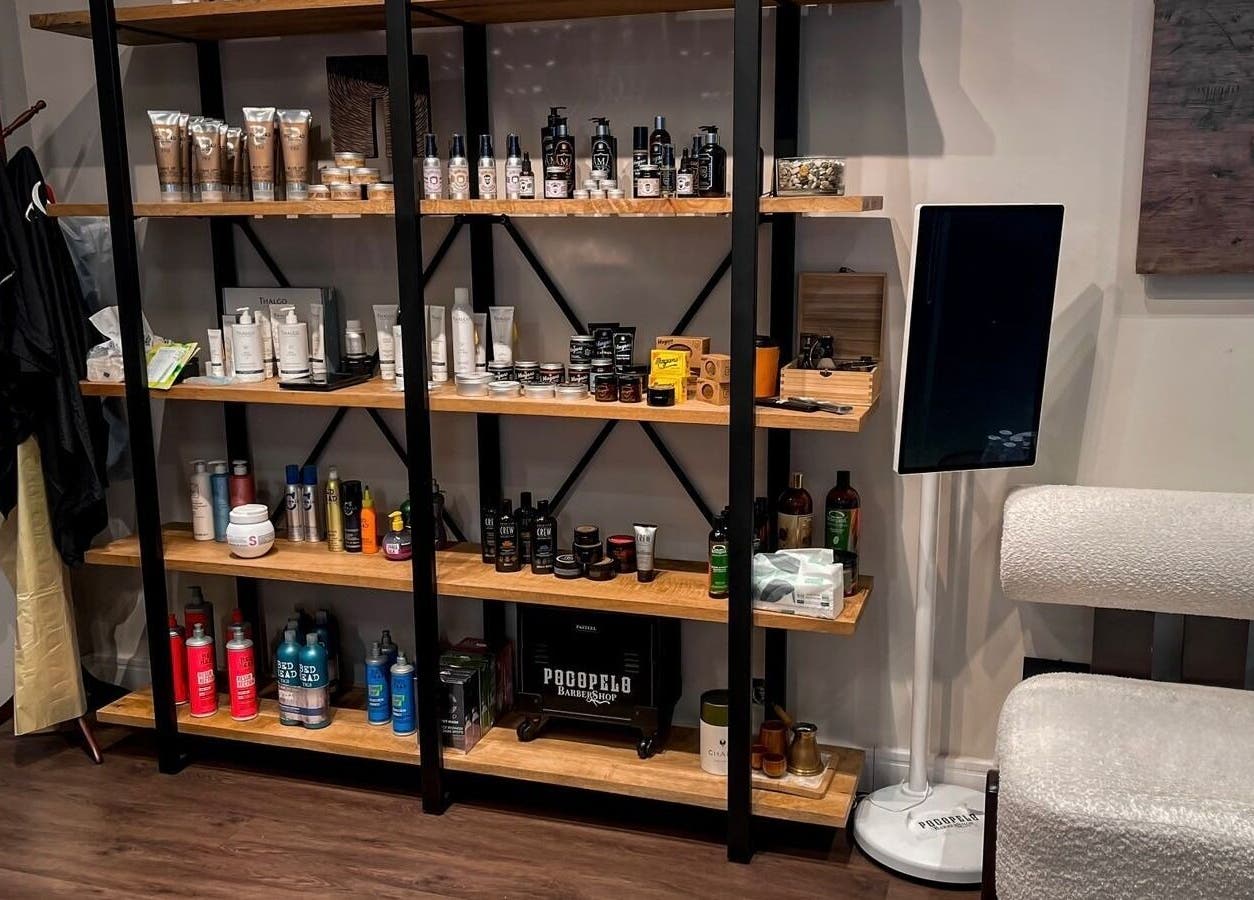 Well-stocked product shelves at Poco Pelo Barbershop in Al Khobar, Eastern Province, SA, showcasing various grooming items.