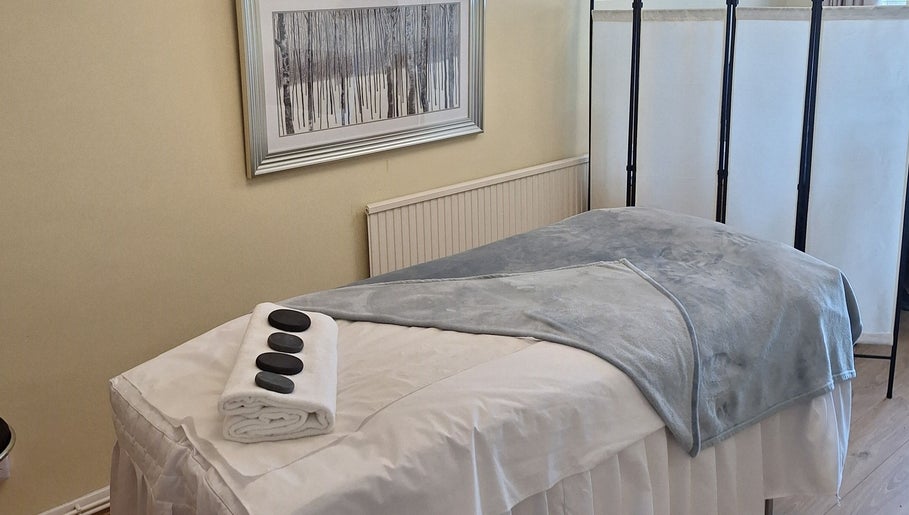 Massage room at Calming-Massage in Blean, England, GB with a cozy table setup.