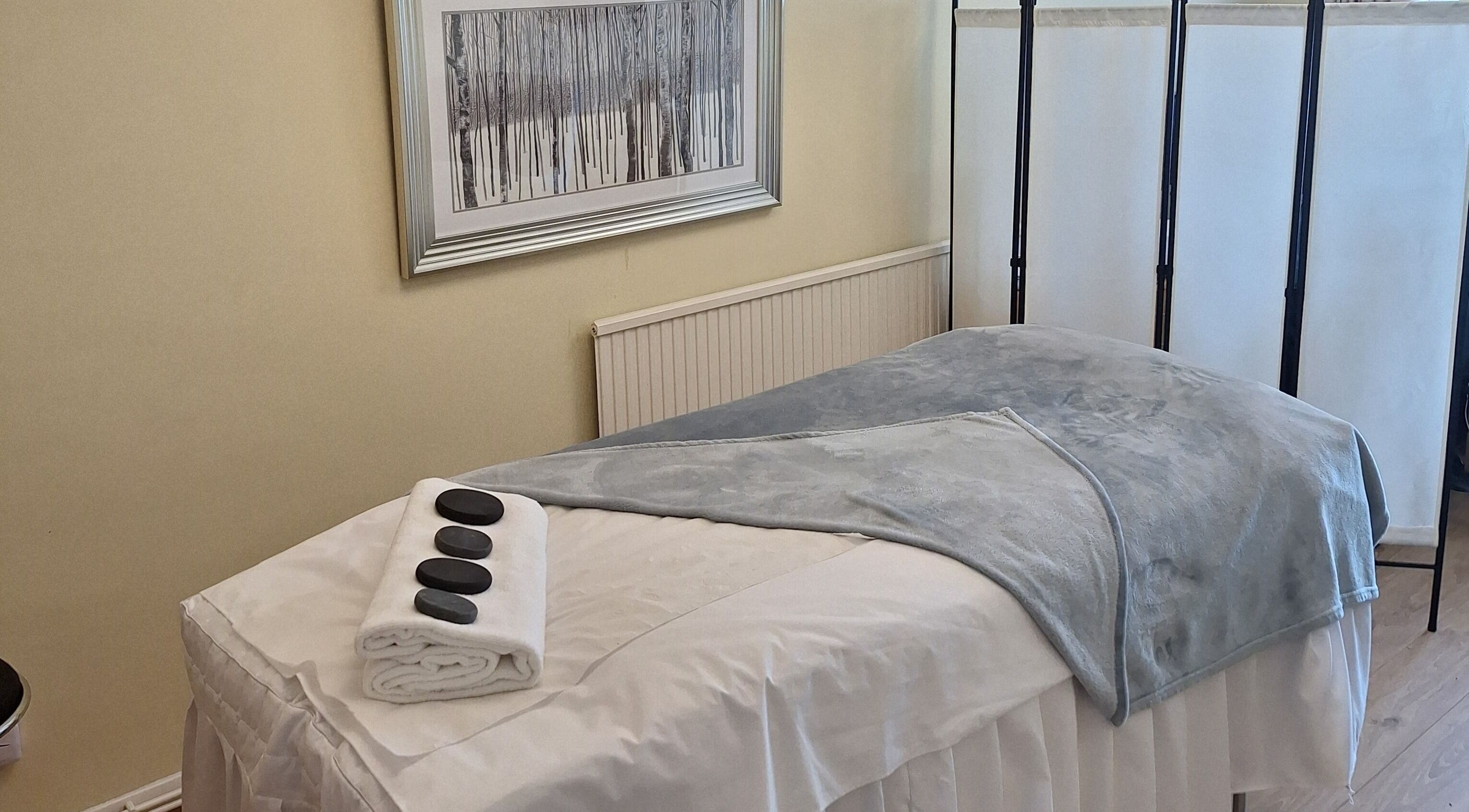 Massage room at Calming-Massage in Blean, England, GB with a cozy table setup.