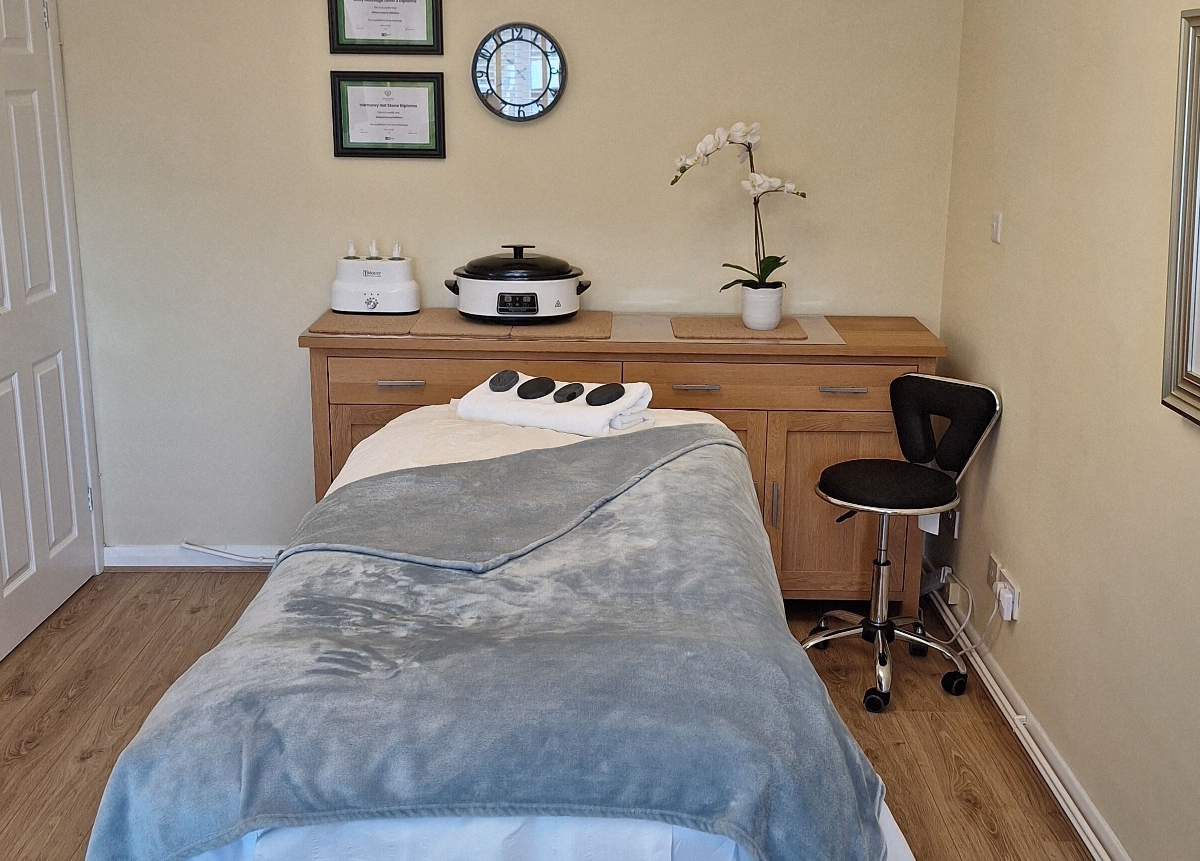 Relaxing spa room at Calming-Massage in Blean, England, GB, featuring a massage table and elegant decor.