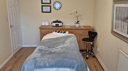 Relaxing spa room at Calming-Massage in Blean, England, GB, featuring a massage table and elegant decor.