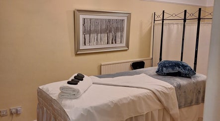 Relaxing massage room at Calming-Massage in Blean, England, GB, featuring a comfortable treatment table.
