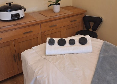 Massage room in Calming-Massage, Blean, England, GB, featuring hot stones and cozy ambiance.