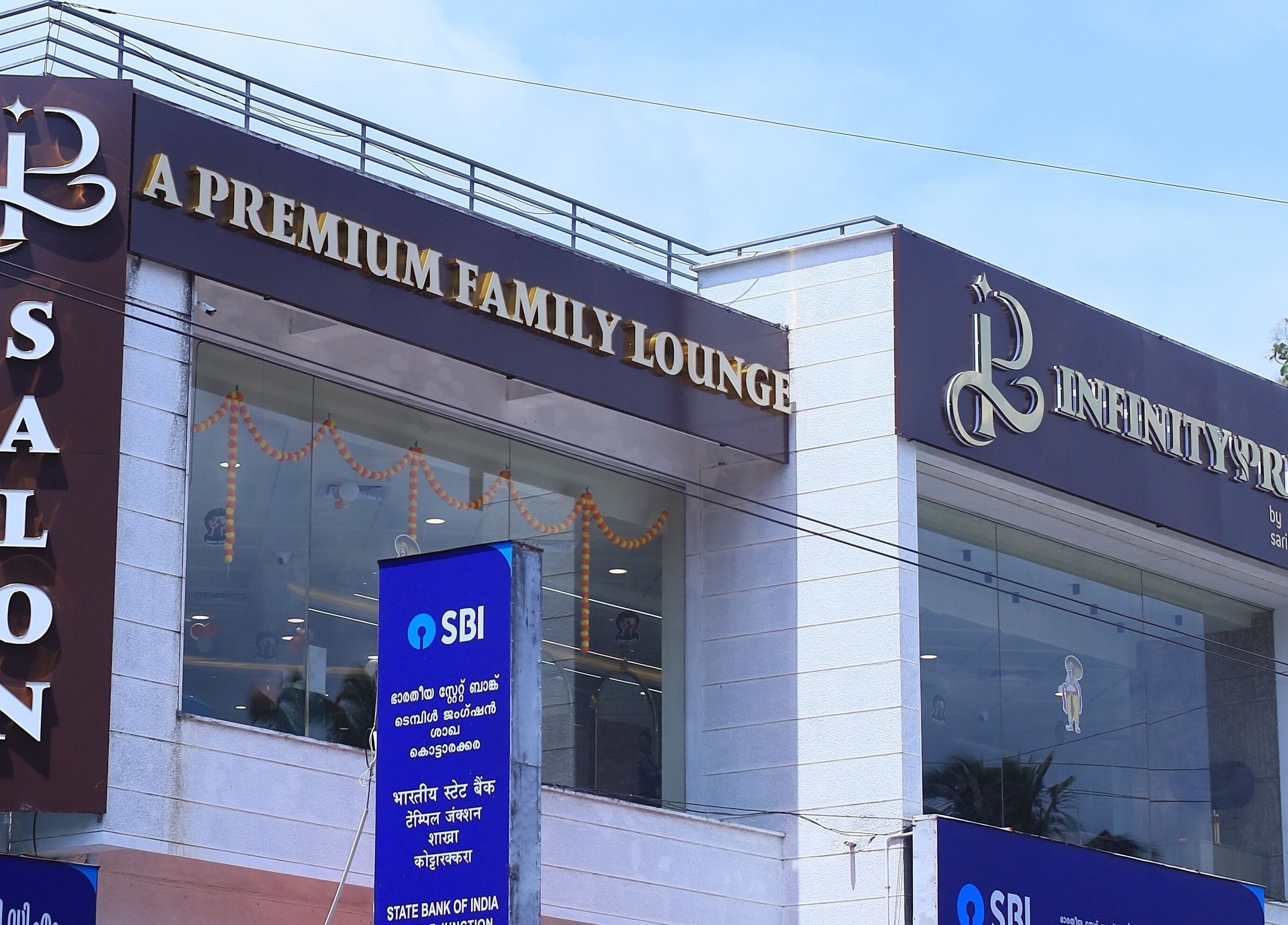 Infinity Pride, a premium salon in Kottarakkara, Kerala, India, showcasing elegant exterior signage.