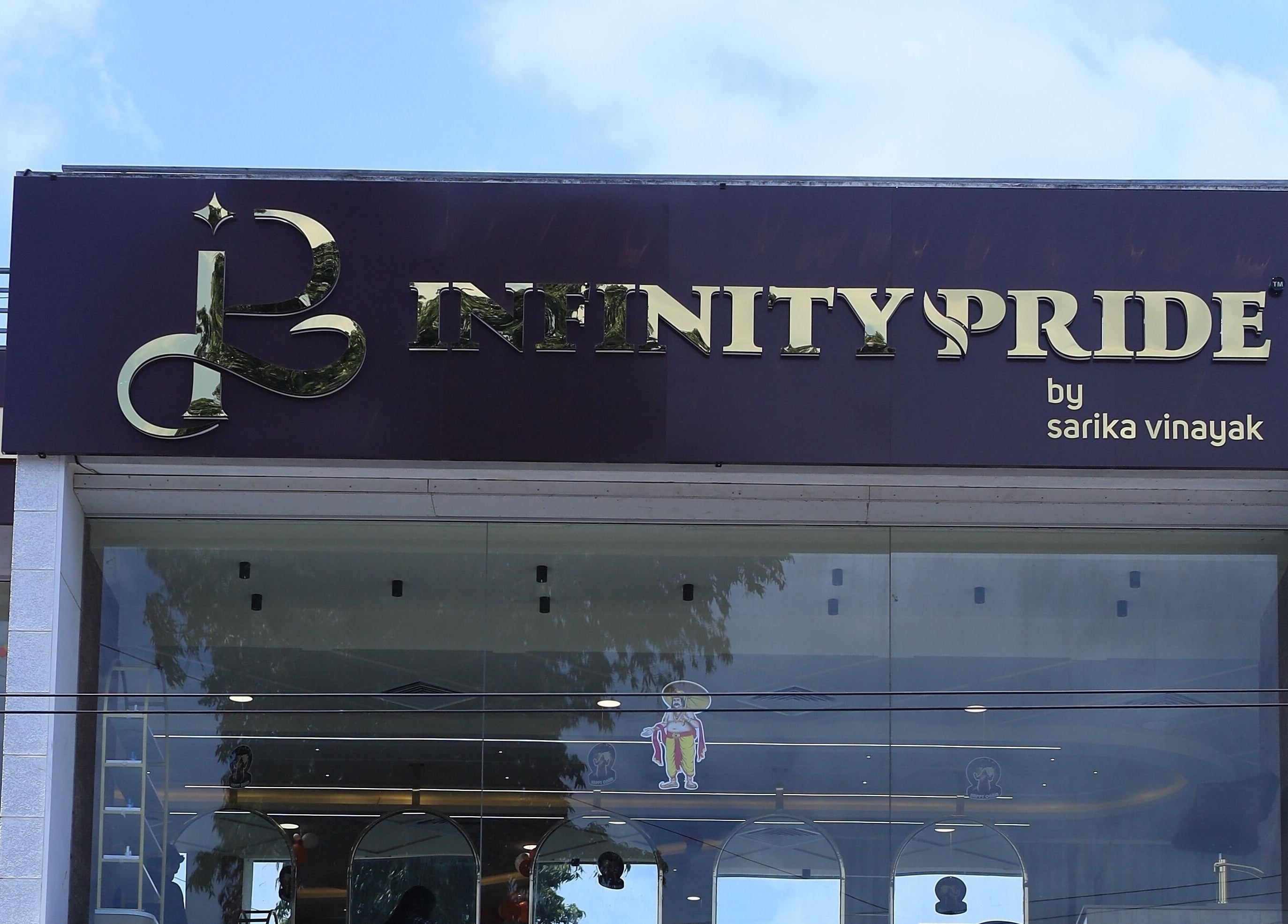 Infinity Pride entrance showcasing elegant signage in Kottarakkara, Kerala, IN.