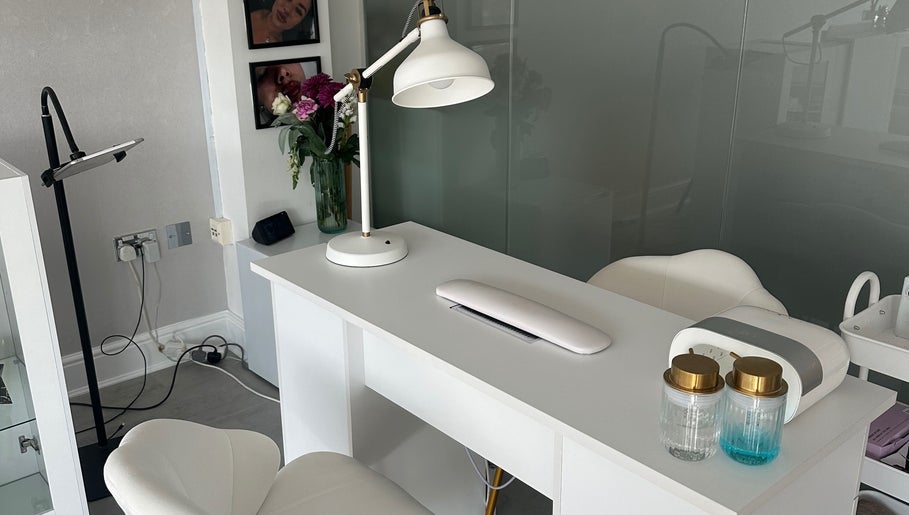 Nail salon workspace at NAILS WITH JESSICA, Willesborough, England, with white desk and chairs.