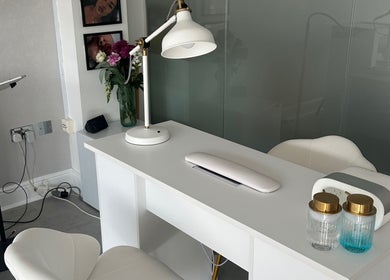 Nail salon workspace at NAILS WITH JESSICA, Willesborough, England, with white desk and chairs.