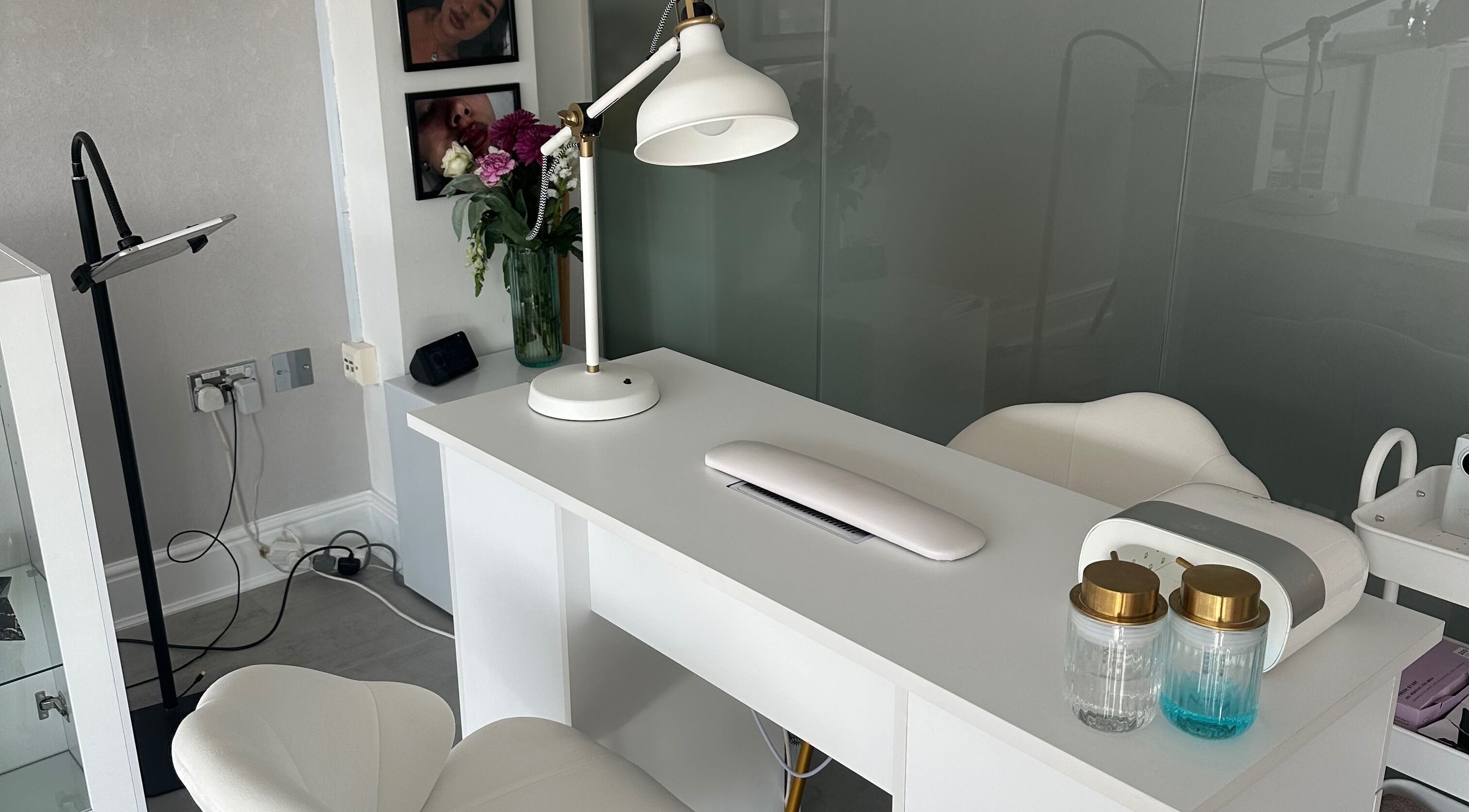 Nail salon workspace at NAILS WITH JESSICA, Willesborough, England, with white desk and chairs.