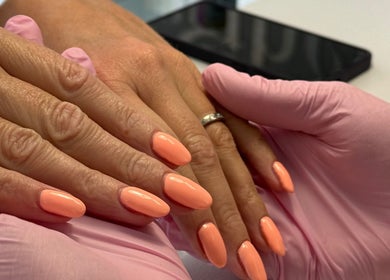 Elegant coral nail manicure at NAILS WITH JESSICA, Willesborough, England, GB showcasing professional styling.