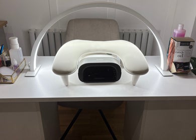 Nailin It by Leona's nail station setup in Hamilton, Scotland, GB, featuring manicure tools and a UV lamp.