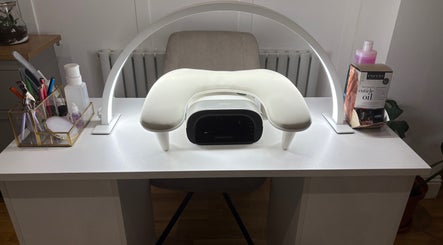 Nailin It by Leona's nail station setup in Hamilton, Scotland, GB, featuring manicure tools and a UV lamp.