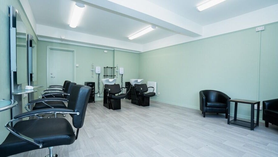 Modern salon interior at Silent Cuts, Downpatrick, Northern Ireland, GB with sleek chairs and wash stations.