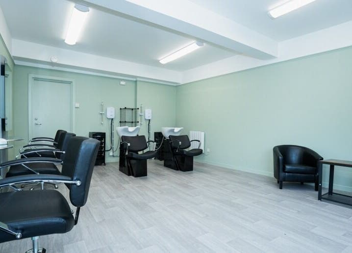 Modern salon interior at Silent Cuts, Downpatrick, Northern Ireland, GB with sleek chairs and wash stations.