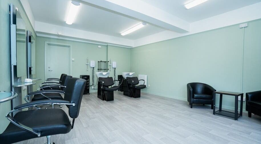 Modern salon interior at Silent Cuts, Downpatrick, Northern Ireland, GB with sleek chairs and wash stations.
