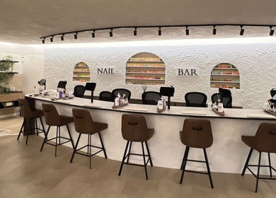 Chic nail bar at Naughty Nails, Birmingham, England, GB with stylish seating and nail polish display.