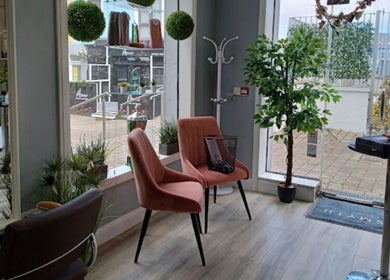Inviting seating area at Deeva Nails Westport, Westport, County Mayo, IE, with plush chairs and greenery.