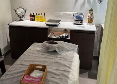 Relaxing spa room at Gramam Living - Spa, Varkala, Kerala, IN featuring a massage table and calming decor.