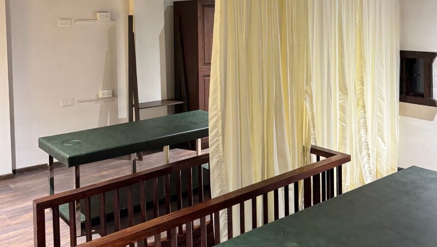 Tranquil massage room with green tables at Gramam Living - Spa, Varkala, Kerala, IN.