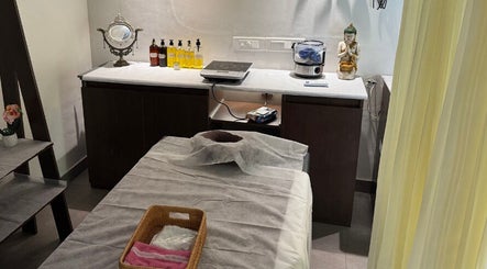 Elegant spa room at Gramam Living - Spa in Varkala, Kerala, IN, featuring massage table and calming decor.