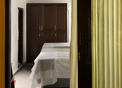 Peaceful treatment room at Gramam Living - Spa, Varkala, Kerala, IN, with massage tables and soft lighting.
