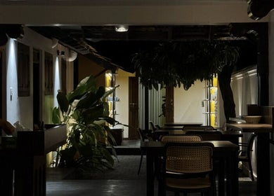 Cozy interior of Gramam Living - Spa in Varkala, Kerala, IN with ambient lighting and lush plants.
