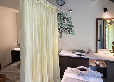Tranquil spa room at Gramam Living - Spa, Varkala, Kerala, IN, featuring soft lighting and elegant decor.