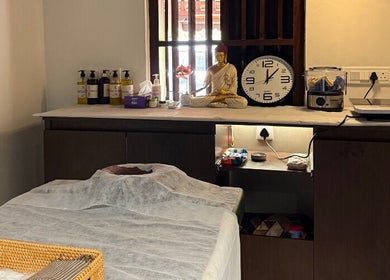 Relaxing spa room at Gramam Living - Spa, Varkala, Kerala, IN, featuring a massage table and calming decor.