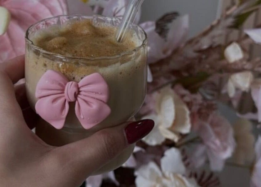 Stylish coffee with pink bow at The Hair Hub, Auckland, NZ surrounded by elegant decor.