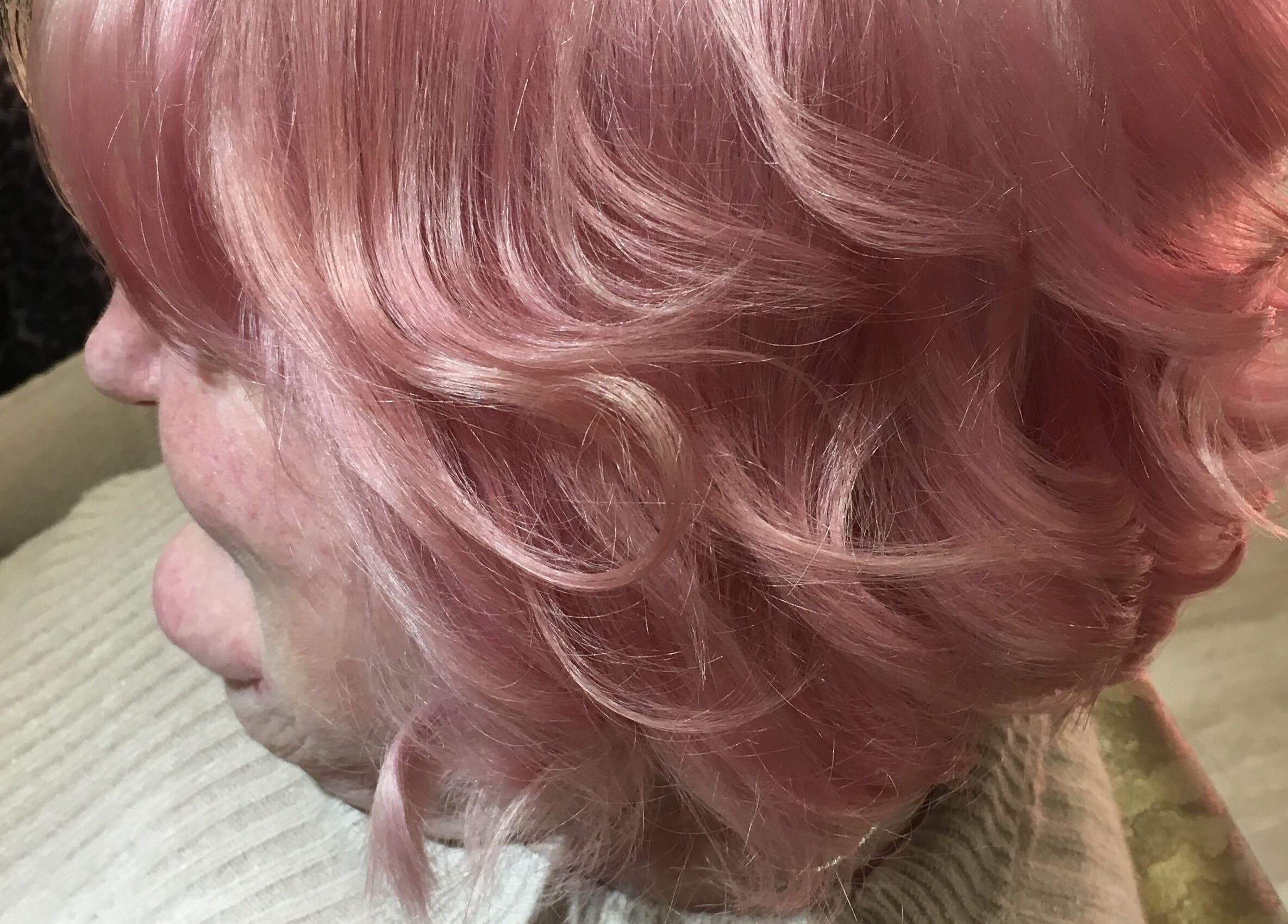 Elegant pink hairstyle at The Hair Hub, Auckland, Auckland, NZ, showcasing vibrant curls.