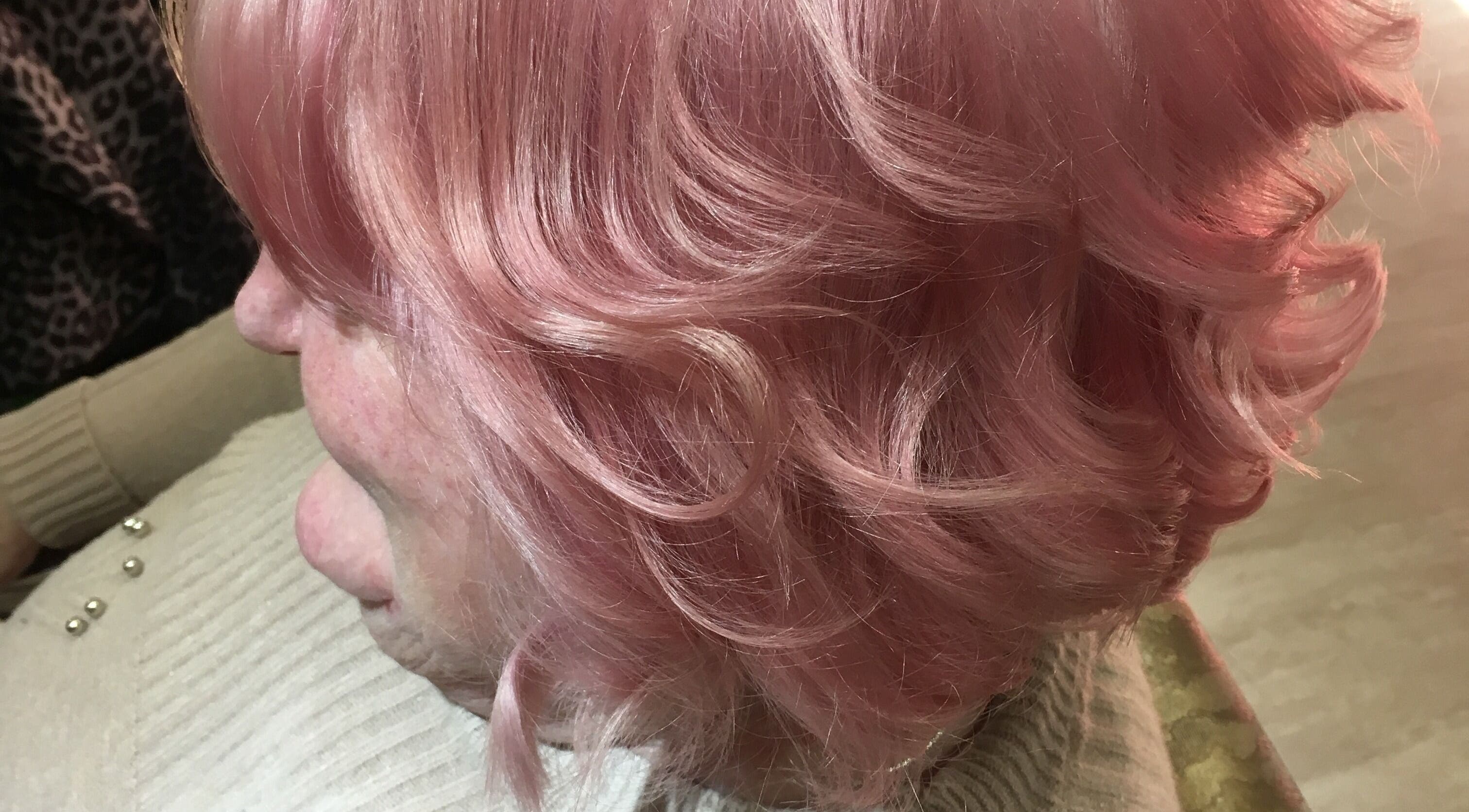 Elegant pink hairstyle at The Hair Hub, Auckland, Auckland, NZ, showcasing vibrant curls.