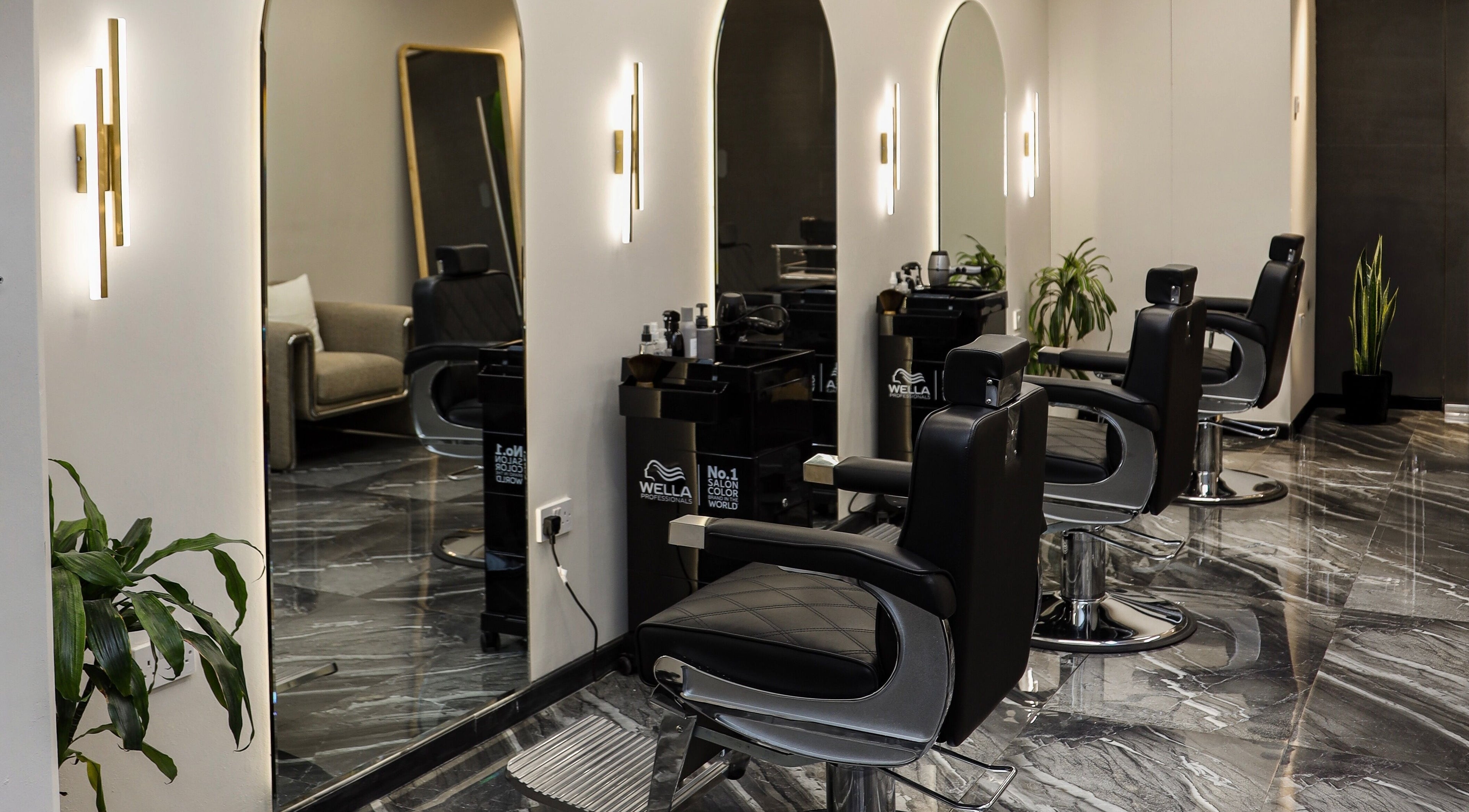 Modern interior of Flair Gents Salon in Abu Dhabi, AE, featuring sleek barber chairs and elegant decor.