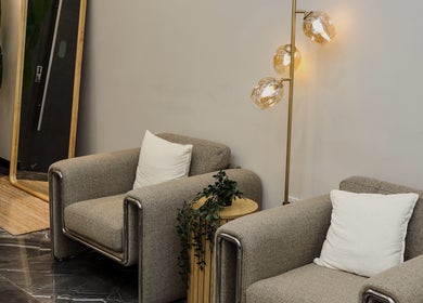 Elegant waiting area at Flair Gents Salon, Abu Dhabi, AE featuring plush chairs and stylish lighting.