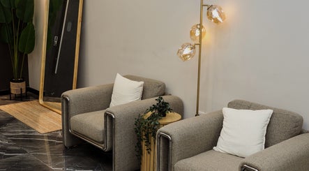 Elegant waiting area at Flair Gents Salon, Abu Dhabi, AE featuring plush chairs and stylish lighting.