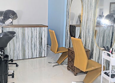 Stylish salon interior at Blueberry Locs Uk, Longfield, England, GB, showcasing modern hairdressing chairs and mirrors.