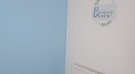 Calm decor at Blueberry Locs Uk, Longfield, England, GB with blue and white walls and stylish logo.