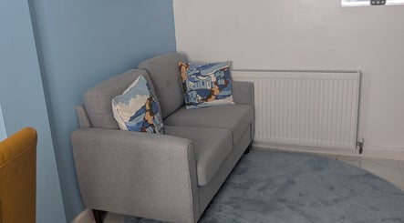 Comfy grey sofa with patterned cushions at Blueberry Locs Uk, Longfield, England, GB.
