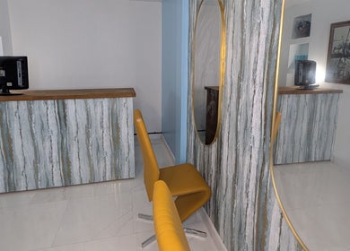 Stylish interior with chair and mirror at Blueberry Locs Uk, Longfield, England, GB.