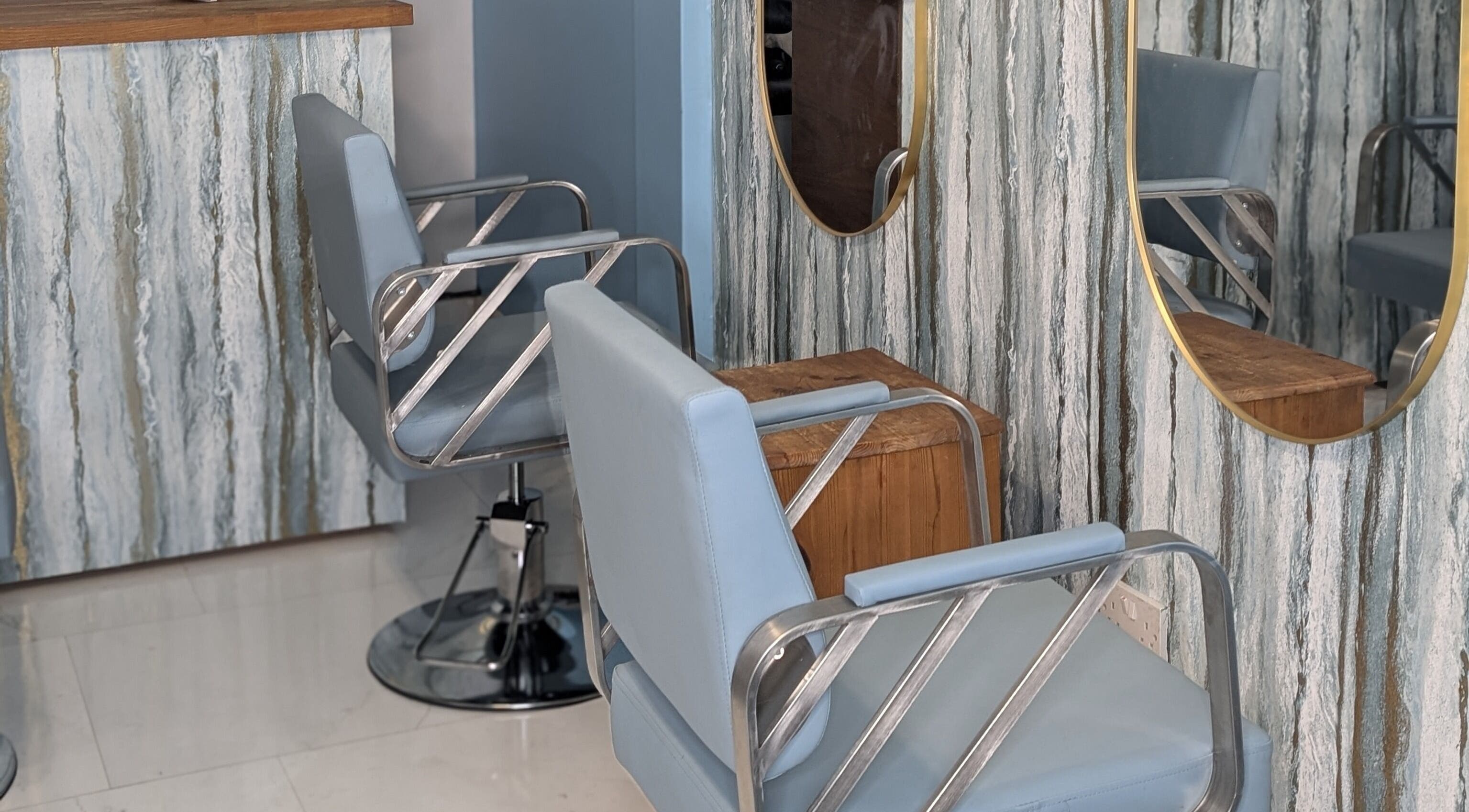 Modern salon chairs and mirrors at Blueberry Locs Uk in Longfield, England, GB.