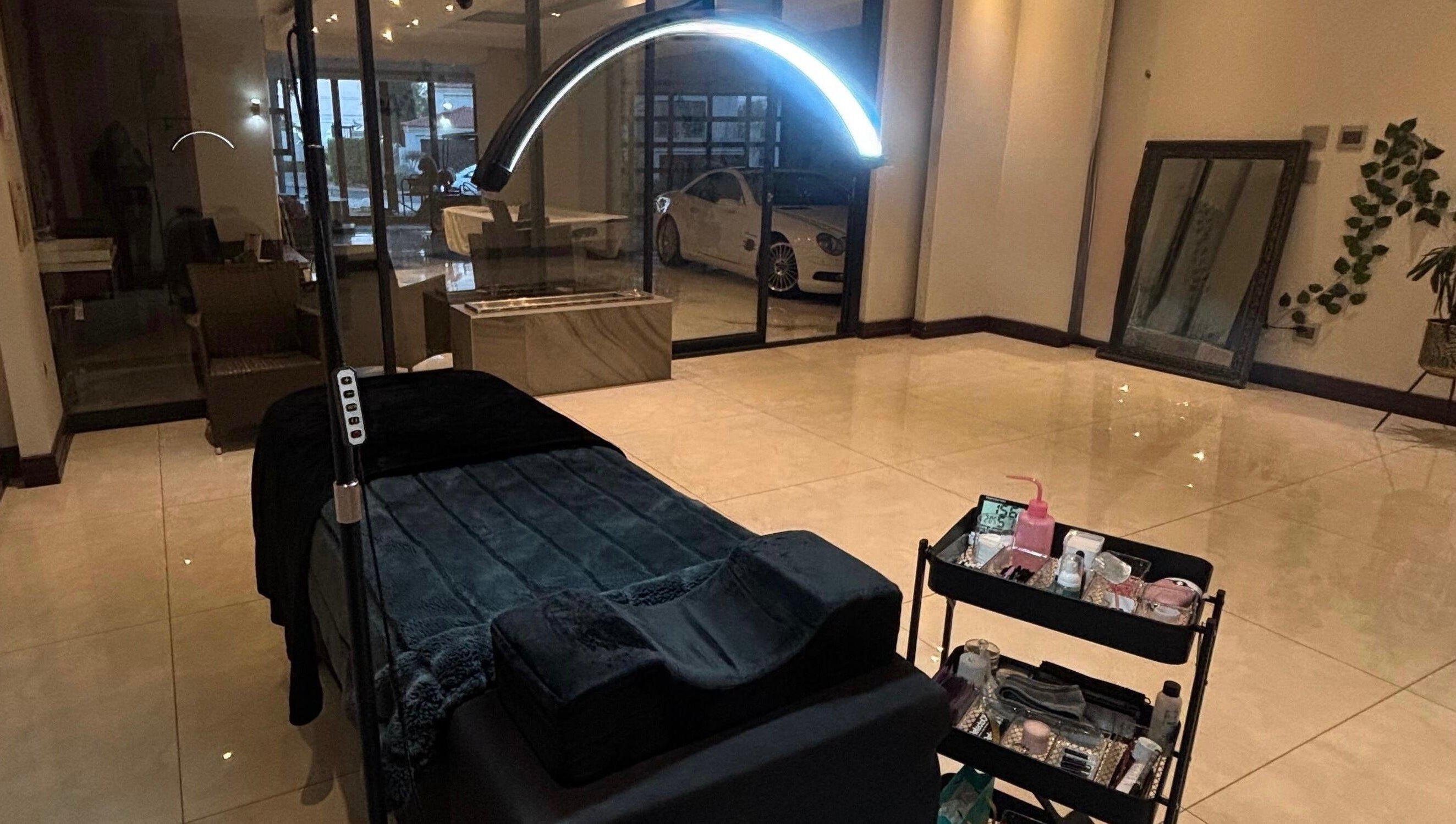 Luxurious treatment room at Aura Lash Studio, Midrand, Gauteng, ZA. Features spa bed and tool trolley.