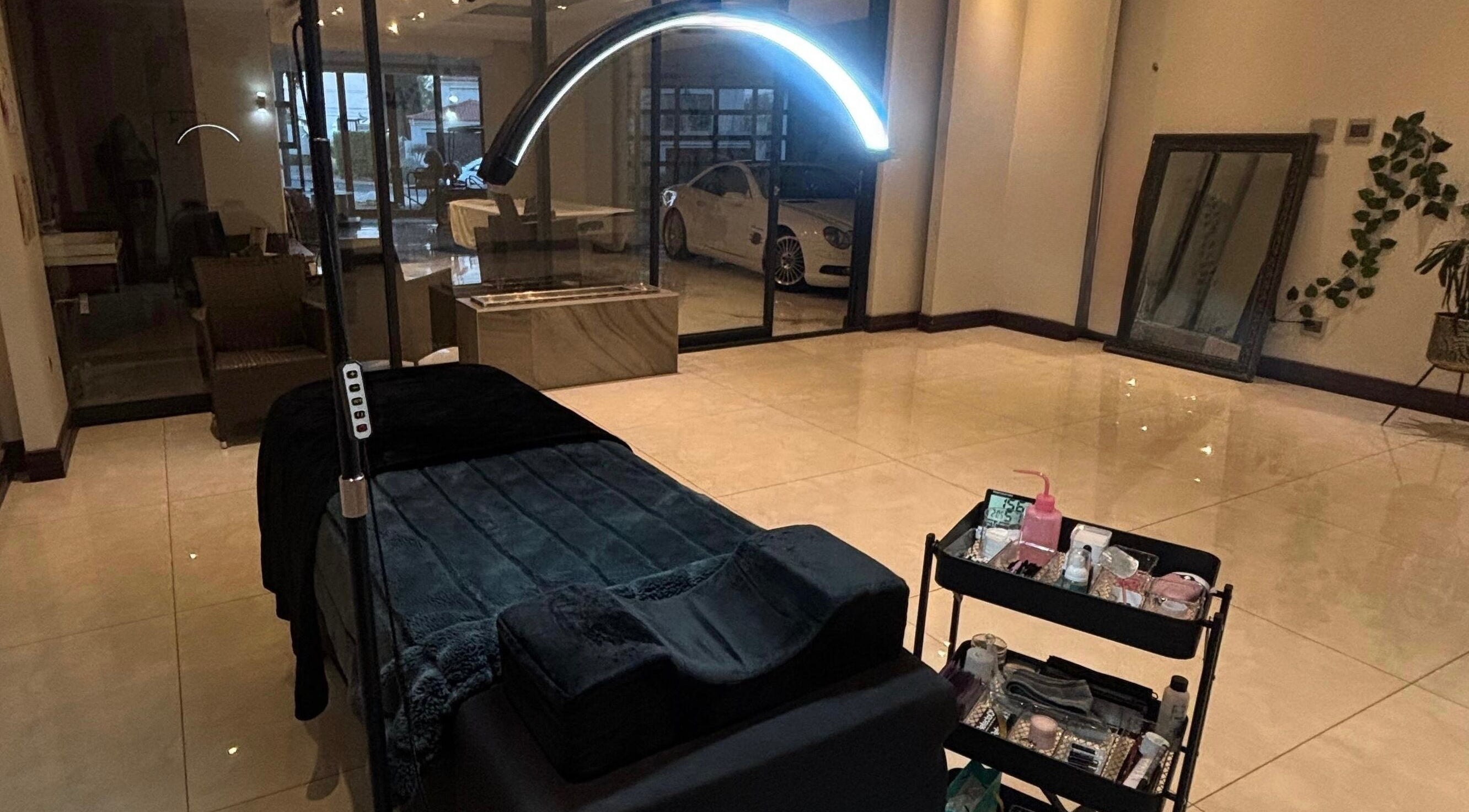 Luxurious treatment room at Aura Lash Studio, Midrand, Gauteng, ZA. Features spa bed and tool trolley.