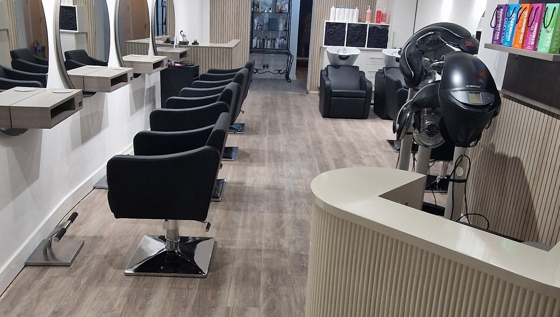 Modern salon interior at Dimensions Different, Gosport, England, GB with stylish seating and equipment.