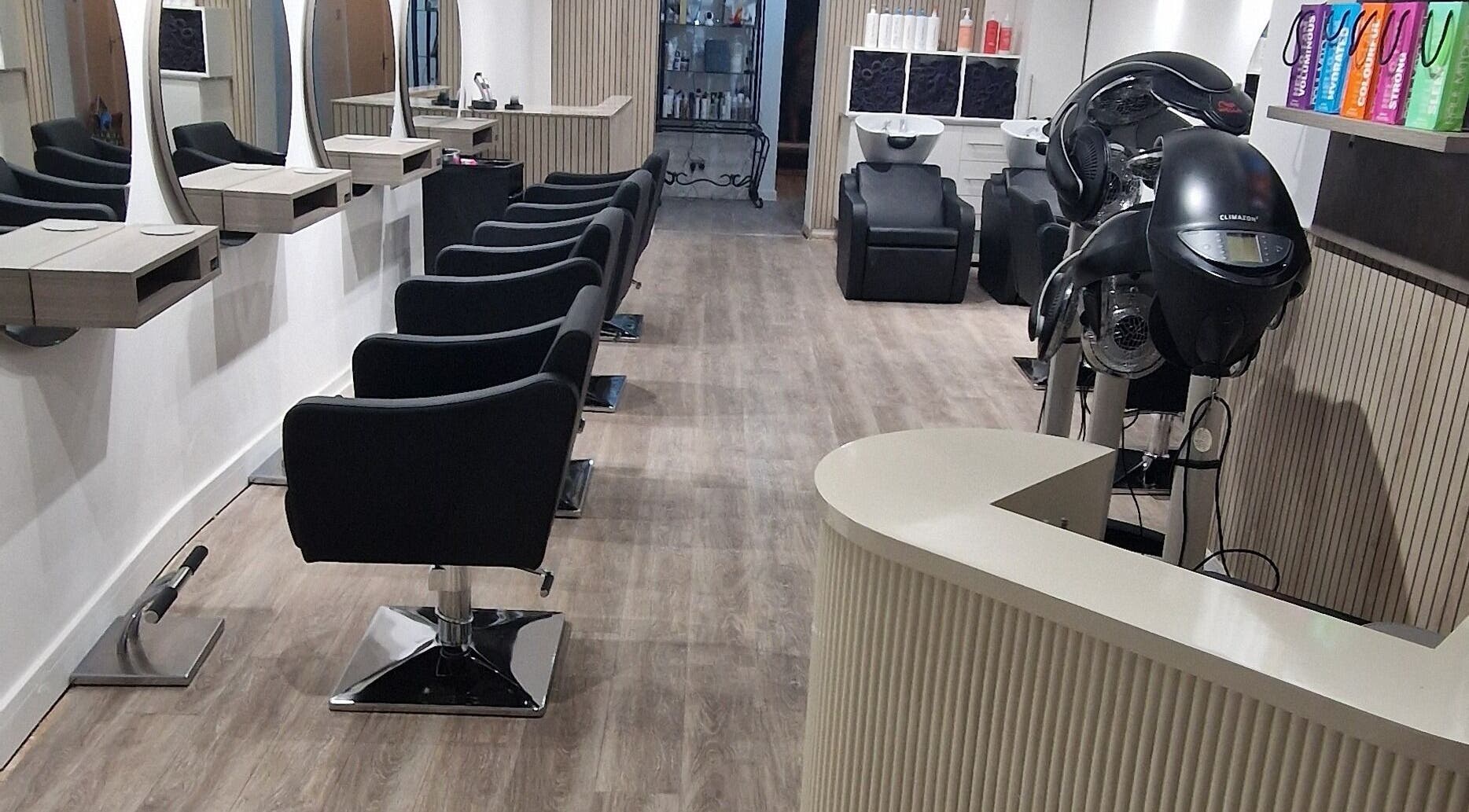 Modern salon interior at Dimensions Different, Gosport, England, GB with stylish seating and equipment.