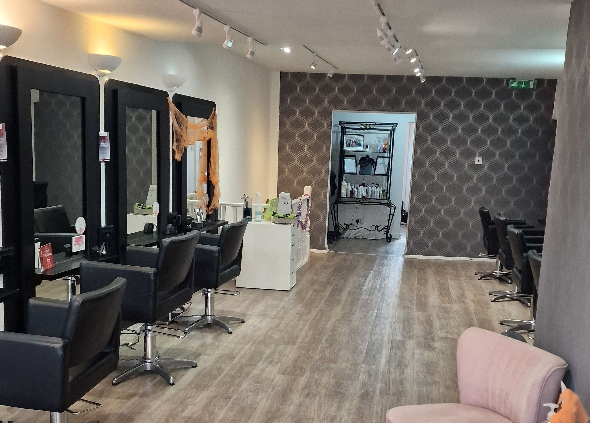 Chic salon interior at Dimensions Different, Gosport, England with modern styling chairs and mirrors.