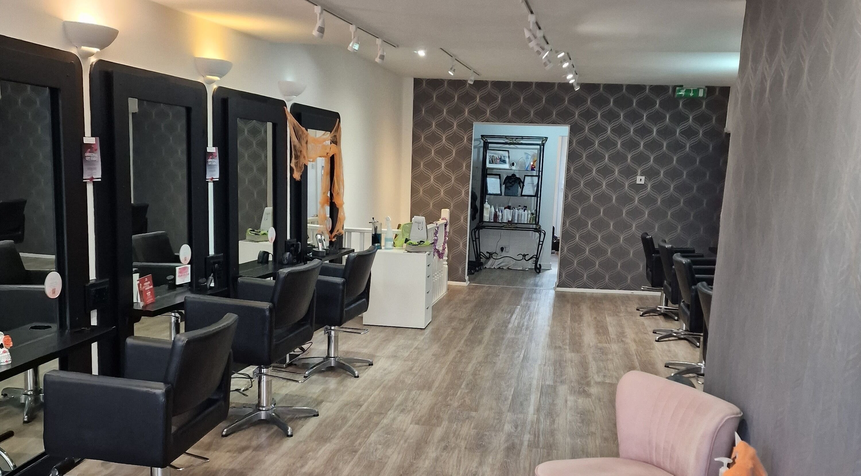 Chic salon interior at Dimensions Different, Gosport, England with modern styling chairs and mirrors.
