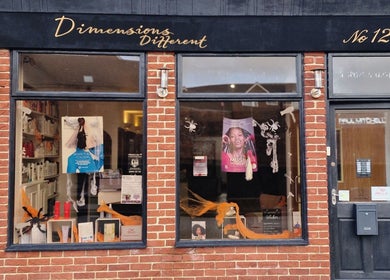 Dimensions Different salon facade featuring stylish window display in Gosport, England, GB.