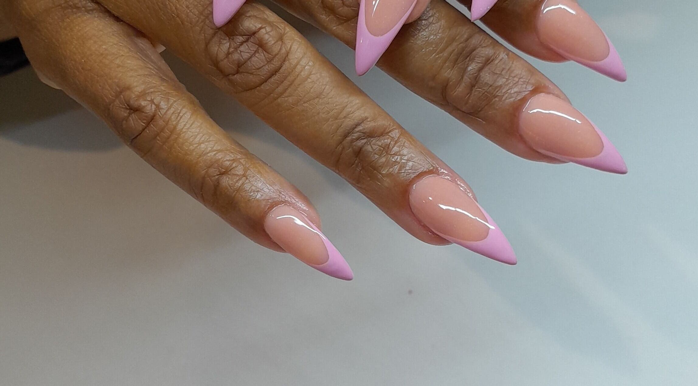 Stylish glossy pink-tipped nails at Emmy's nails, Cape Town, Western Cape, ZA.