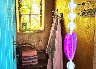 Inviting entry at Plas Courtyard Spa, Llanbedr, Wales with cozy robes and soft lighting.